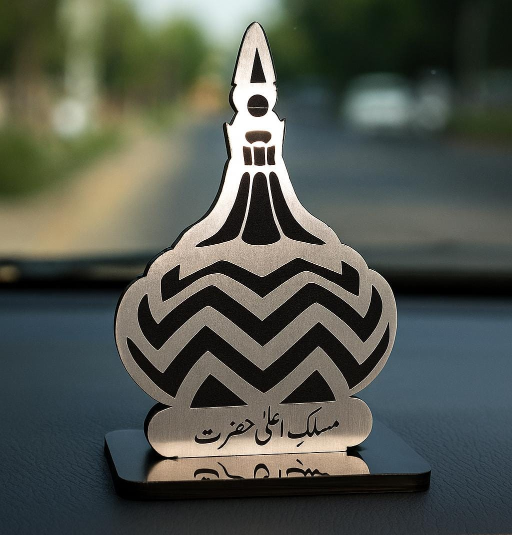 Decorative metal object with black zigzag pattern on a blurred background