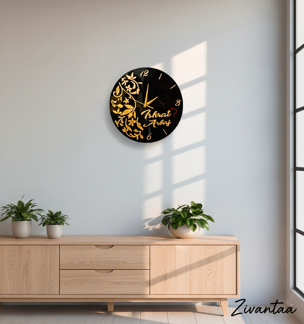 Decorative wall clock with gold designs on a light gray wall above a wooden cabinet.