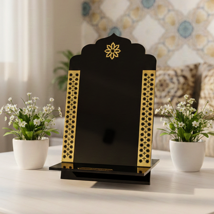 Decorative black and gold object on a table with potted plants