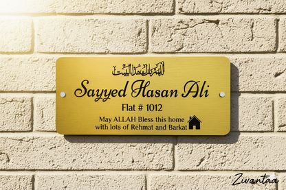 Gold nameplate with engraved text on a brick wall background