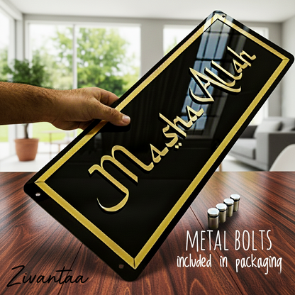 Hand holding a black metal sign with 'môshs Allah' text, placed on a wooden surface with a blurred indoor background.