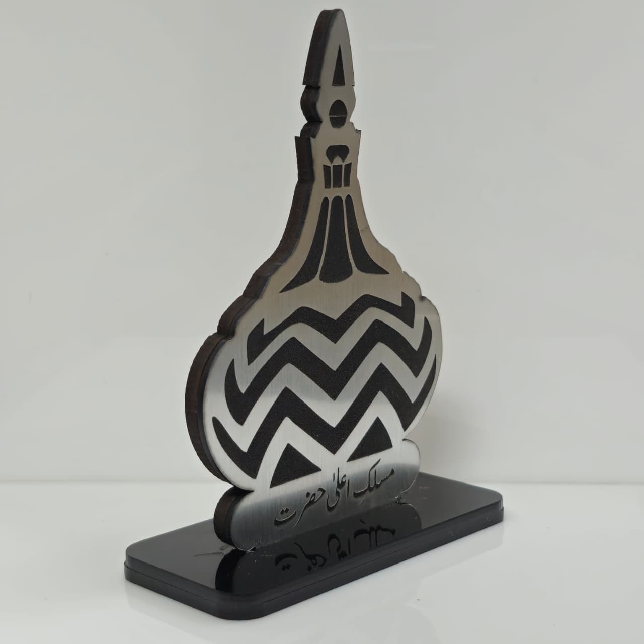 Decorative object with black and gray design on a white background