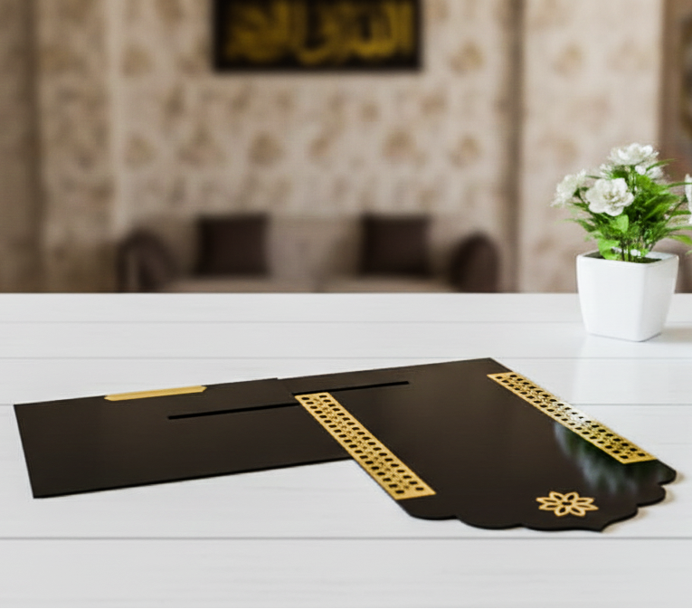 Decorative black and gold mat on a white surface with a blurred background