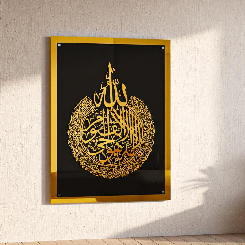 Decorative wall art with Arabic calligraphy in a gold frame on a white acreylic gold black design wall.