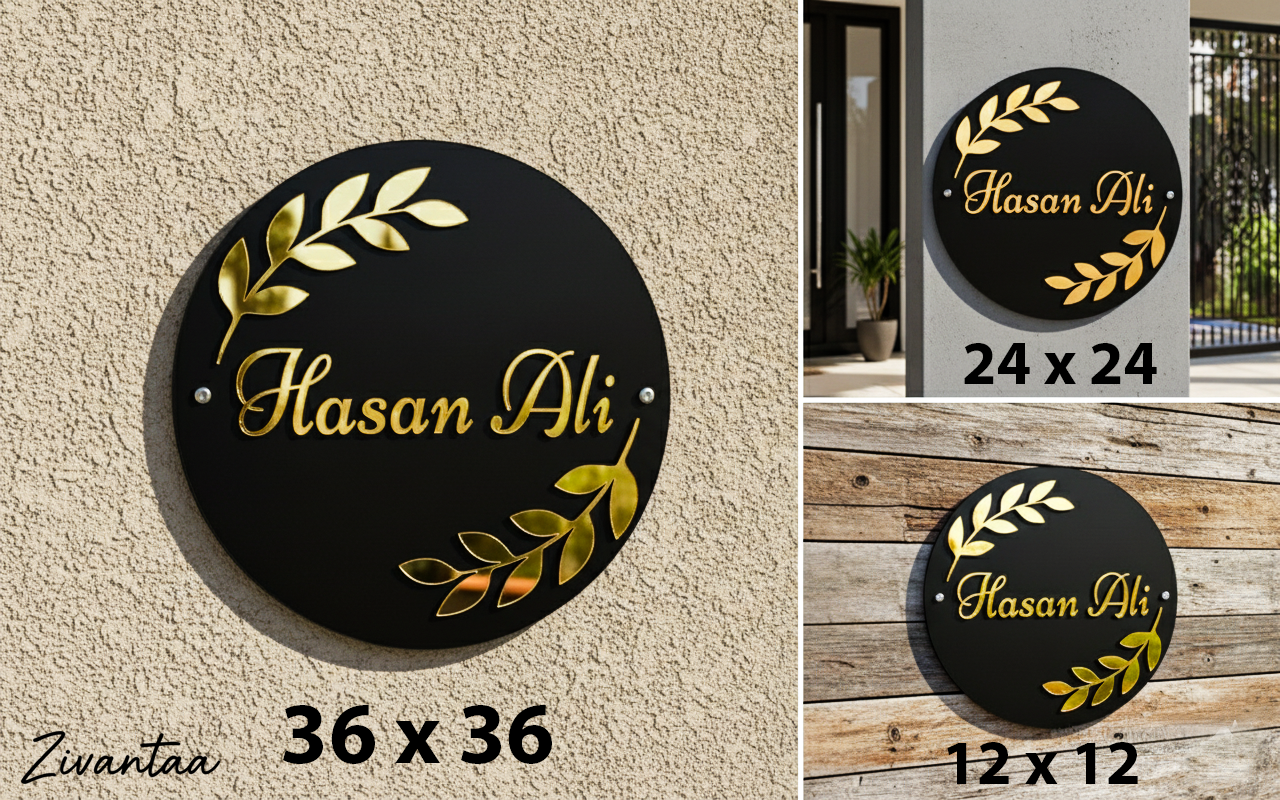 Round black sign with gold text and leaf designs, displayed on a wall and wooden surface.