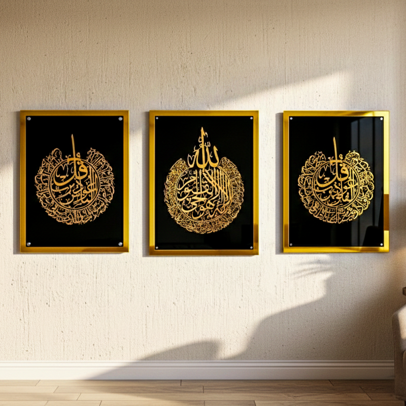 Three framed pieces of art with gold calligraphy on a black background, mounted on a wall.